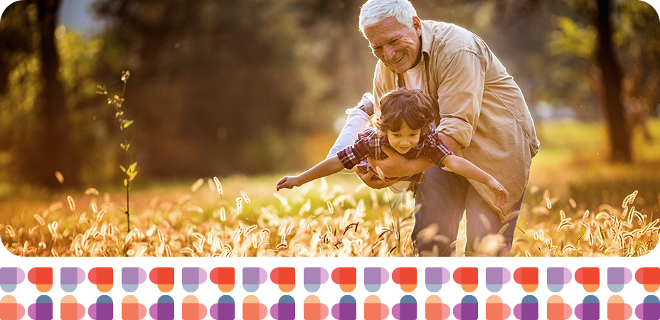 Grandpa and grandchild playing in the field